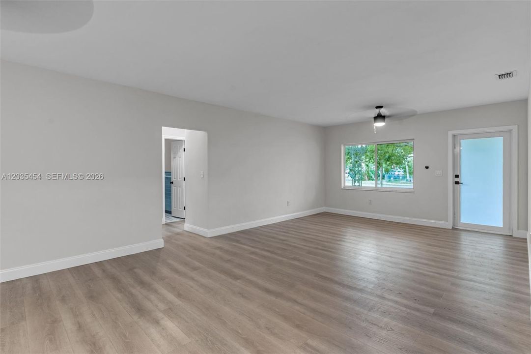 In living room  looking back at view of front door. all windows and doors impact
