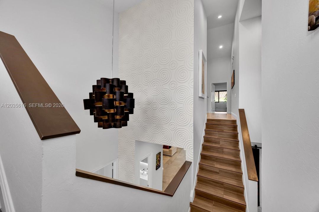 Split staircase leads to the Primary Bedroom on one side and 2nd Bedroom on another.