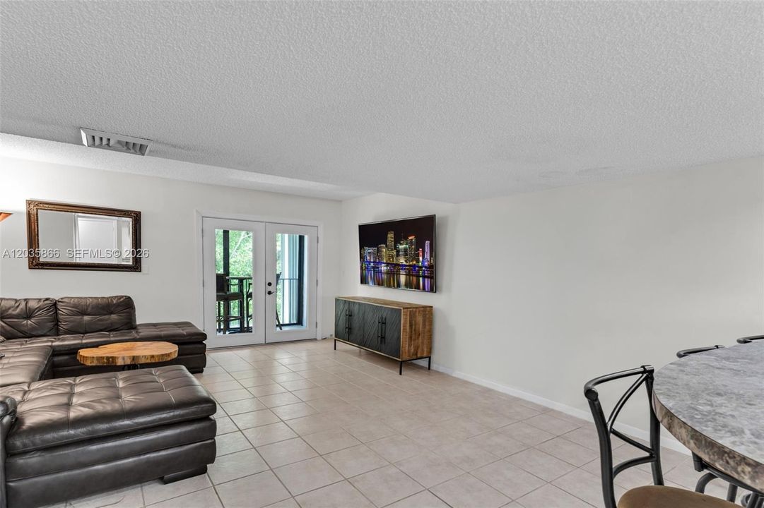 FAMILY ROOM LEADING OUT TO STUNNING SCREENED PATIO