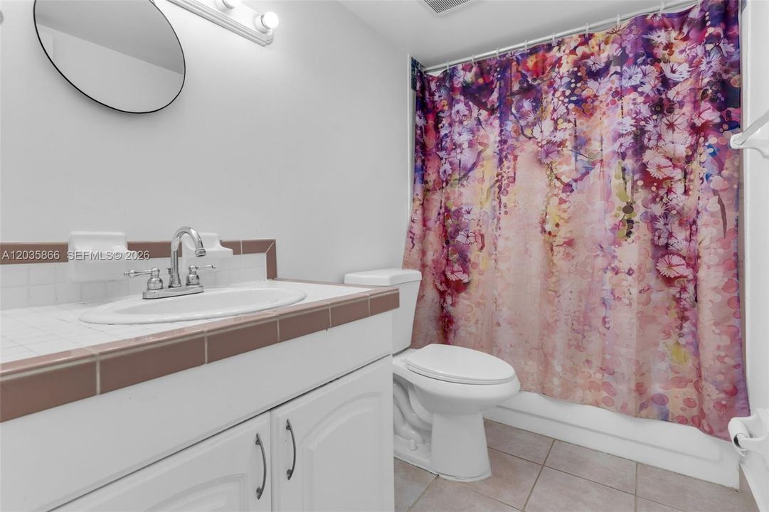 FULL BATHROOM WITH TUB AND SHOWER.