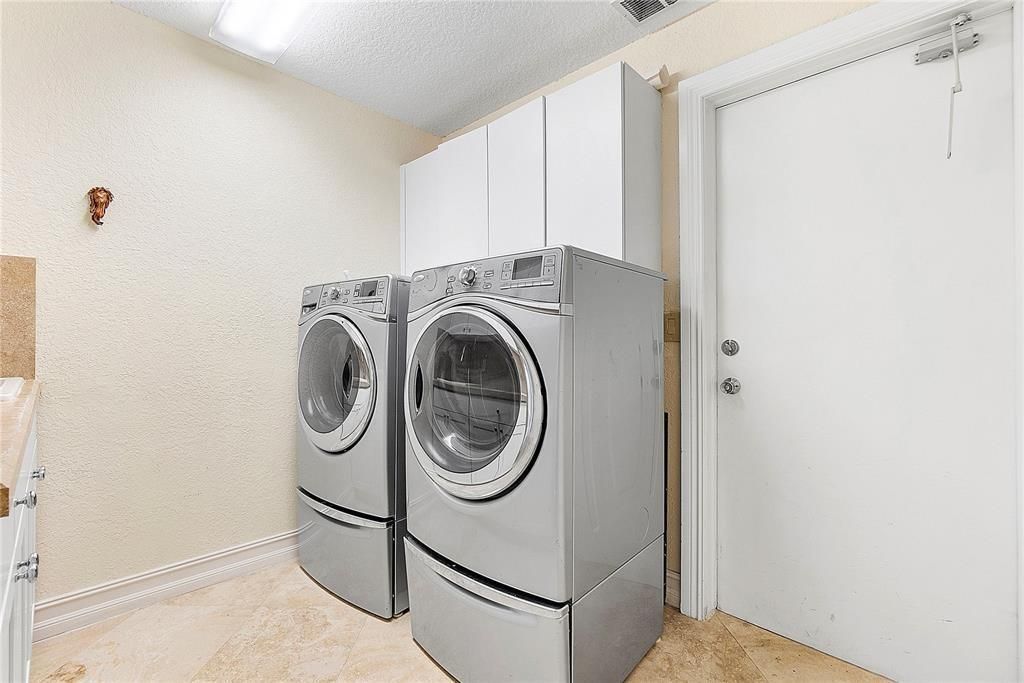 Large laundry room with utility sink.