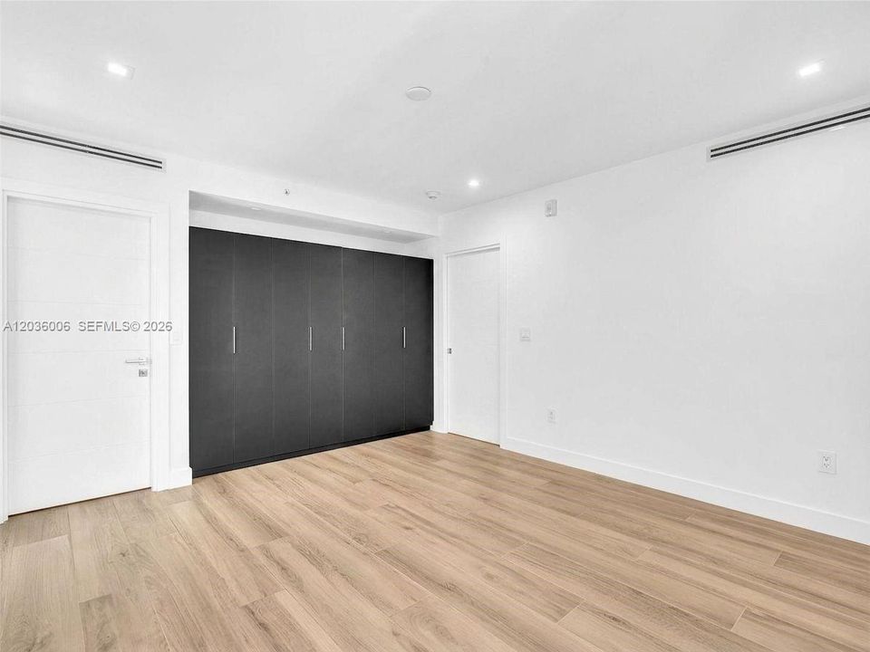 Bedroom with Wall unit closets