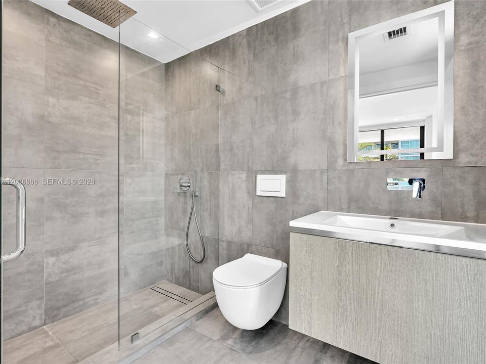 Bath with glass shower.