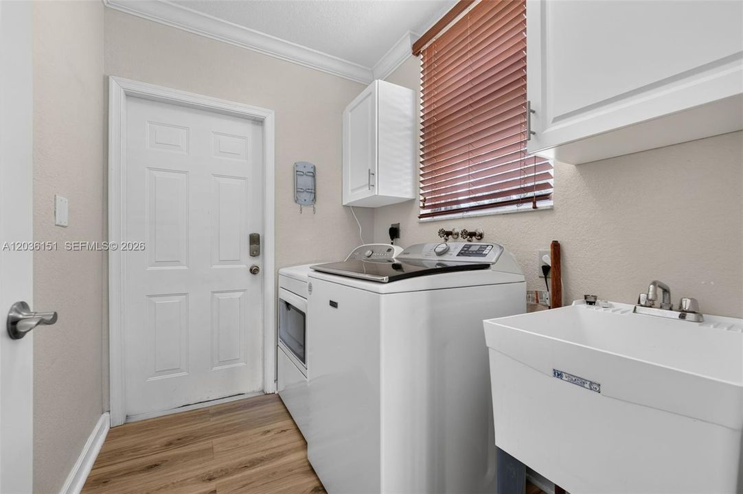 Custom cabinets, utility sink, access to the garage