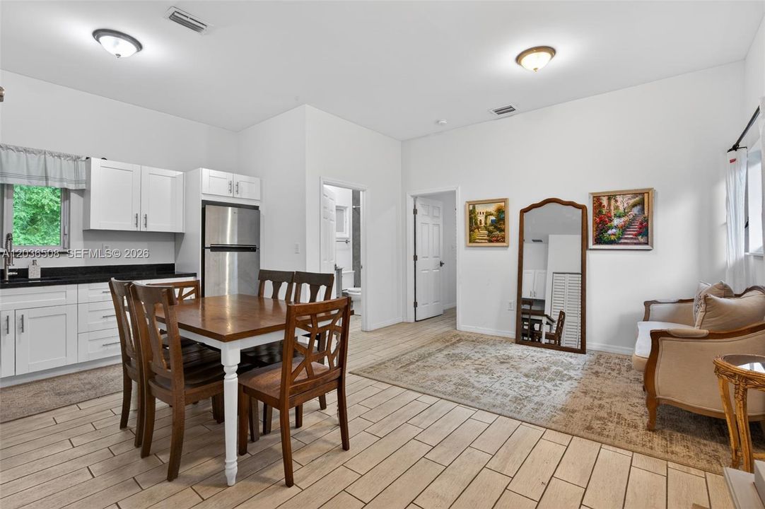 Guest house with full kitchen, full bathroom with double sink, and bedroom (currently utilized as bridal suite prep area)