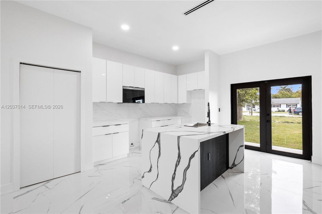 Gorgeous kitchen with a huge pantry and a waterfall quartz island.