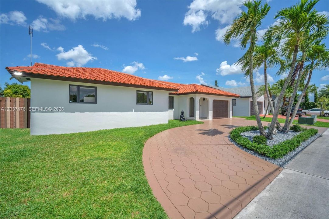 Front of home with large driveway that fits over 3 vehicles.