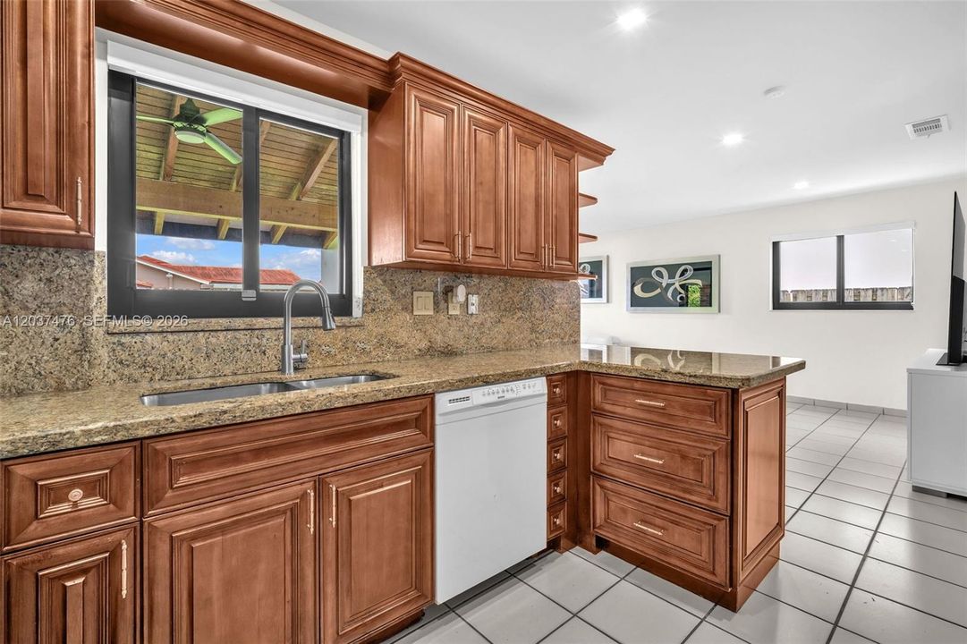 Open kitchen with window bar to exterior backward.