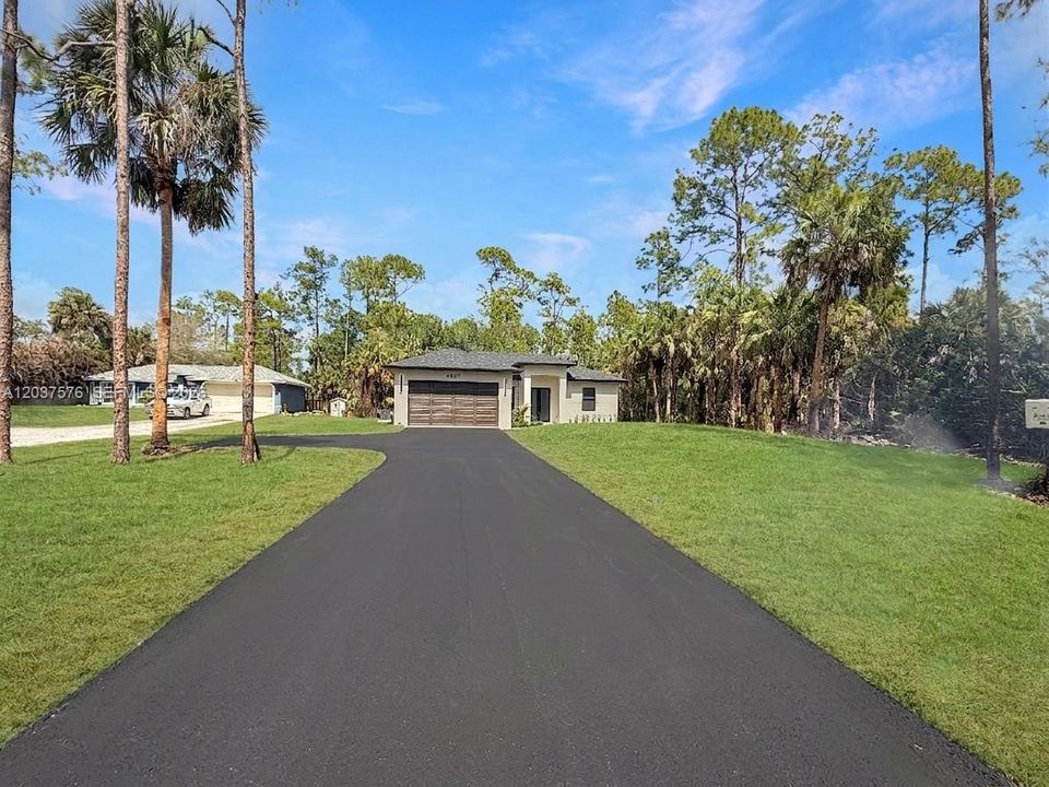 Contemporary single-story residence featuring and a paved driveway
