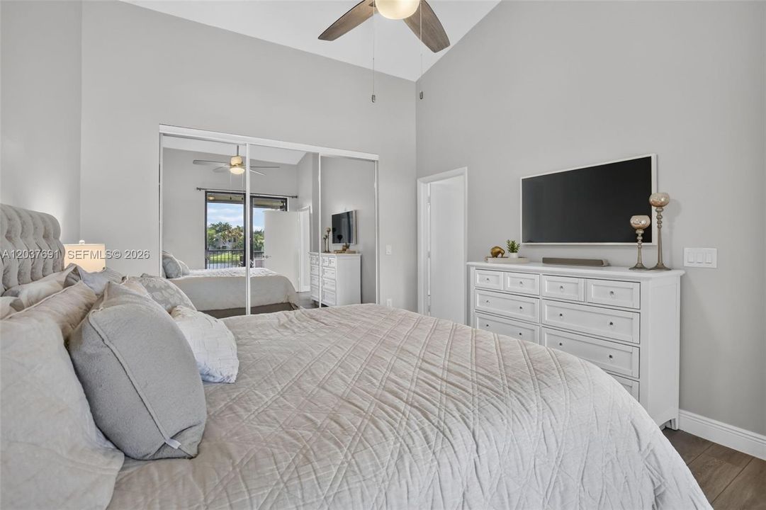 Wake up to peaceful water views from this spacious primary suite with balcony access and abundant natural light