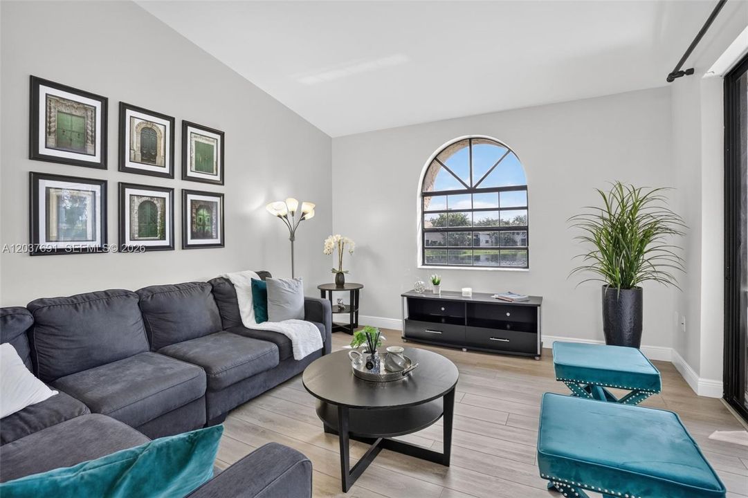 Spacious living room offers an airy open feel, abundant natural light and serene water views