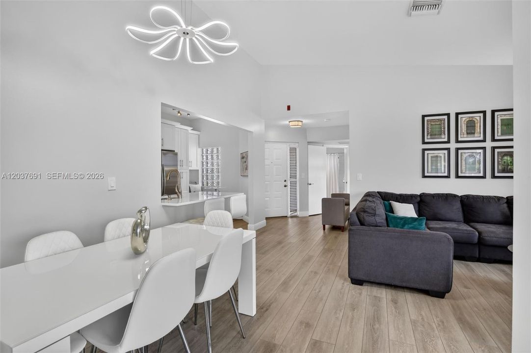 Dining area opens effortlessly to the renovated kitchen and living spaces, ideal for entertaining