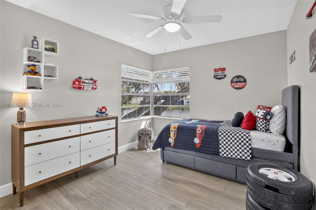Bright secondary bedroom features corner windows, abundant natural light and peaceful water views