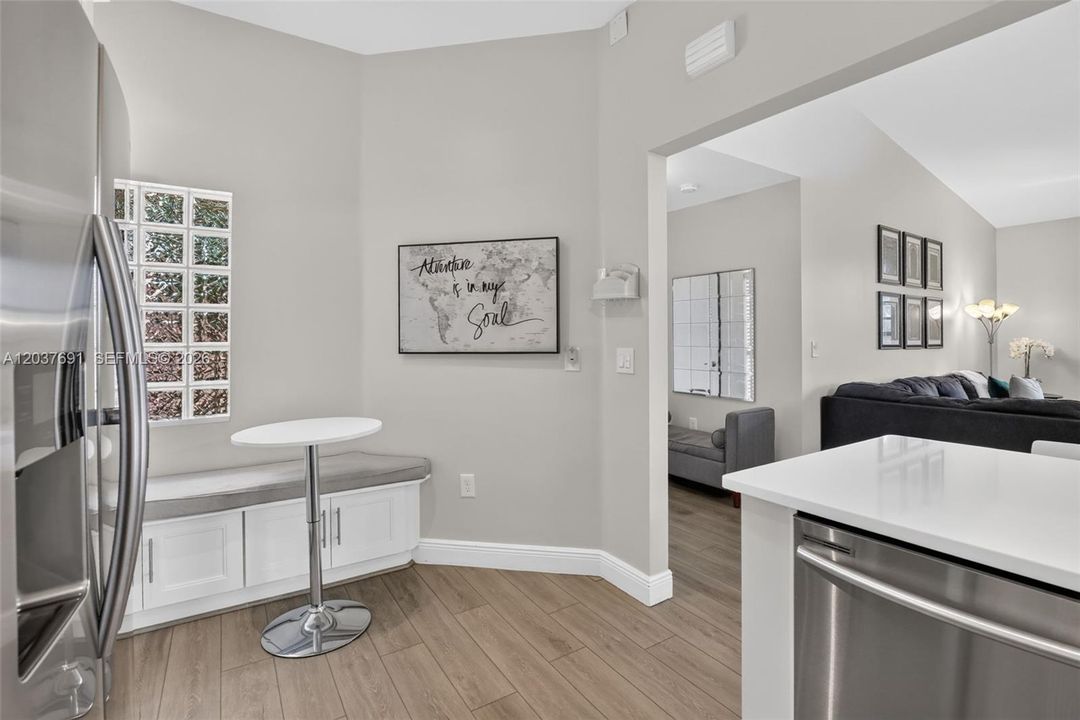A custom built-in breakfast nook with integrated storage creates the perfect spot for morning coffee, casual meals or catching up on emails while maximizing both function and style