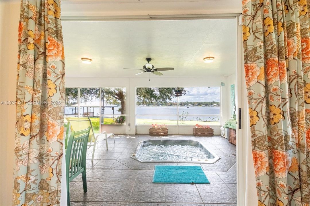 Hot tub in screen porch overlooking at the lake