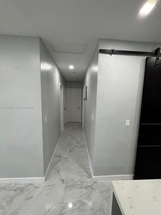Hallway to rooms and bathroom