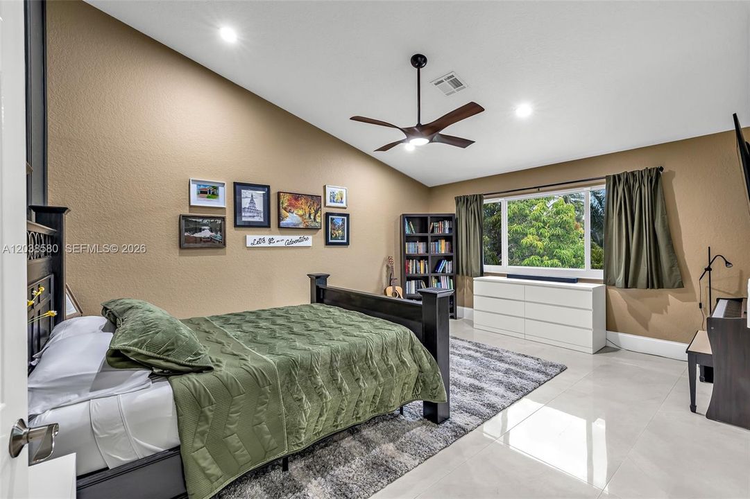 SPACIOUS PRIMARY BEDROOM WITH VIEW OF POOL AND WATER