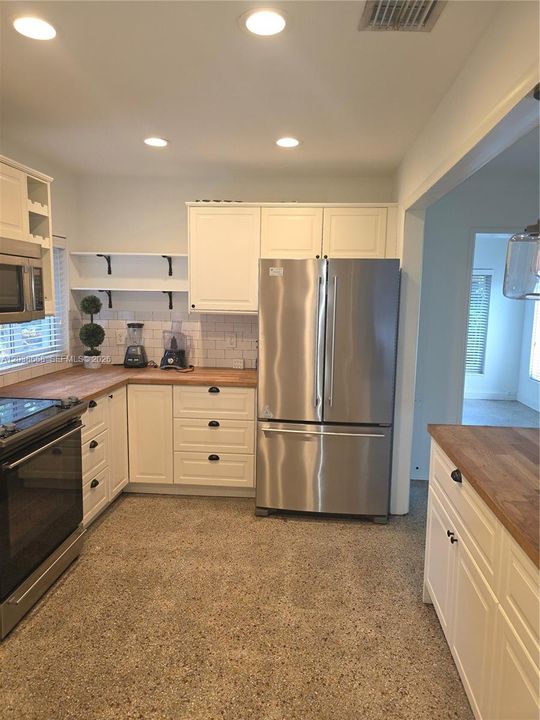 REMODELED KITCHEN WITH STAINLESS STEEL APPLIANCES