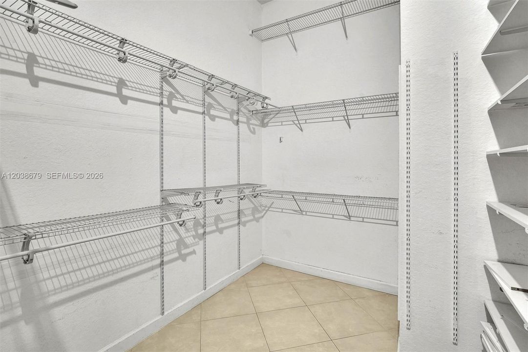 Primary bedroom walk in closet
