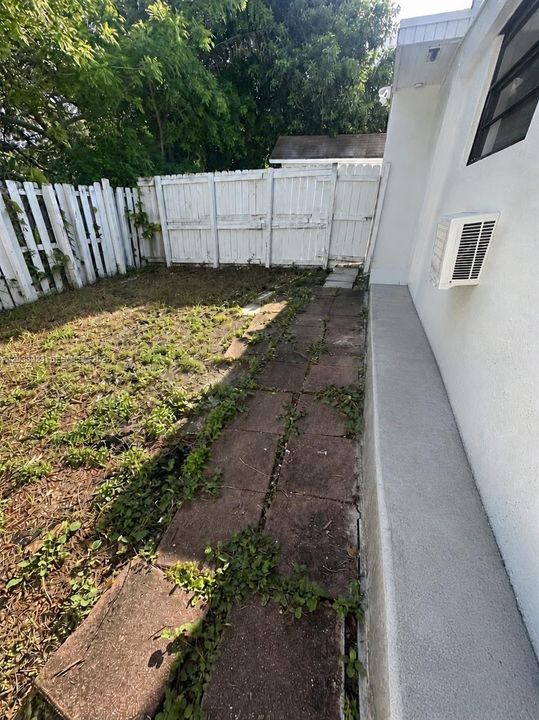Side walkway through white fence