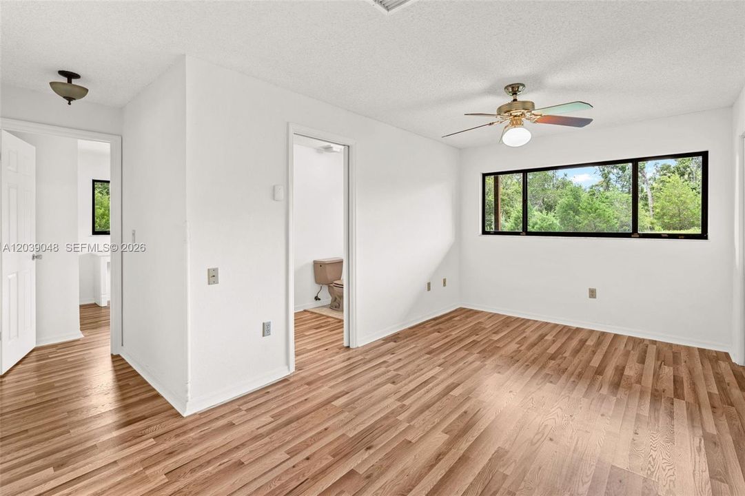 Comfortable guest bedroom offering a peaceful retreat with a functional layout and natural light.
