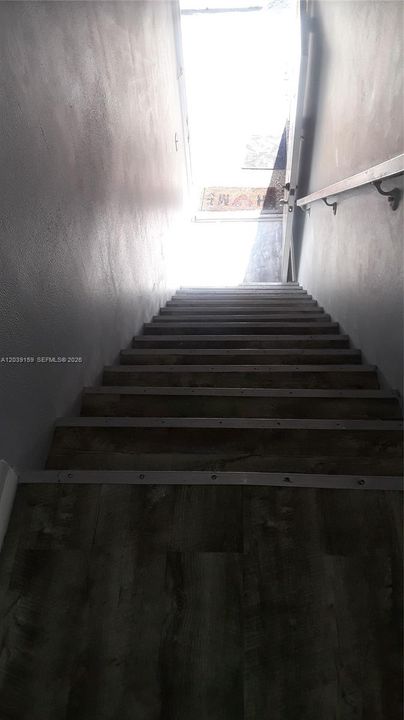 Stairs going down to front door