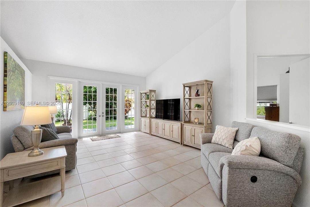 Large living room with french doors to patio & fully fenced yard