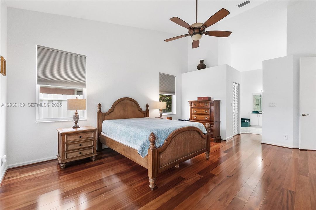 Large primary bedroom with engineered wood flooring