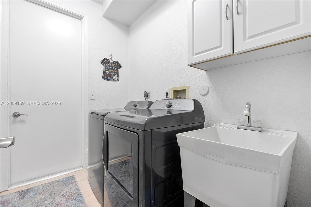 Indoor laundry with newer washer & dryer