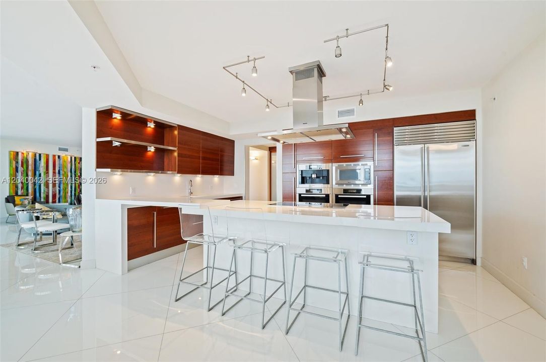 Modern open kitchen with large center island, custom cabinetry, and premium appliances.