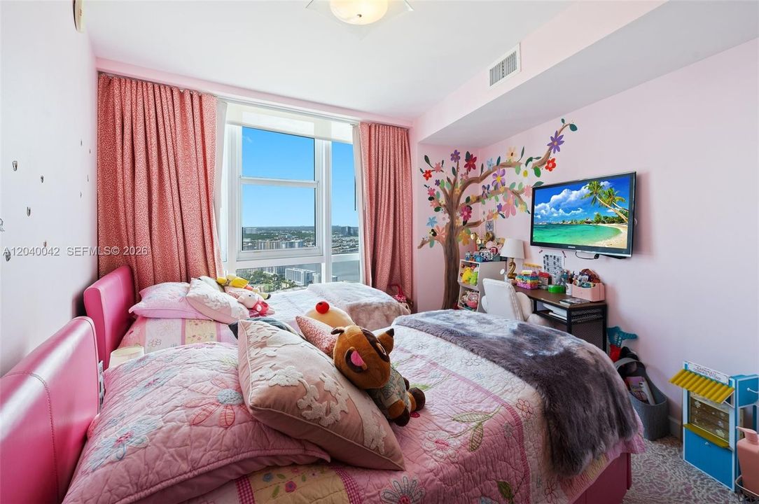 Children’s bedroom with custom mural and playful design.