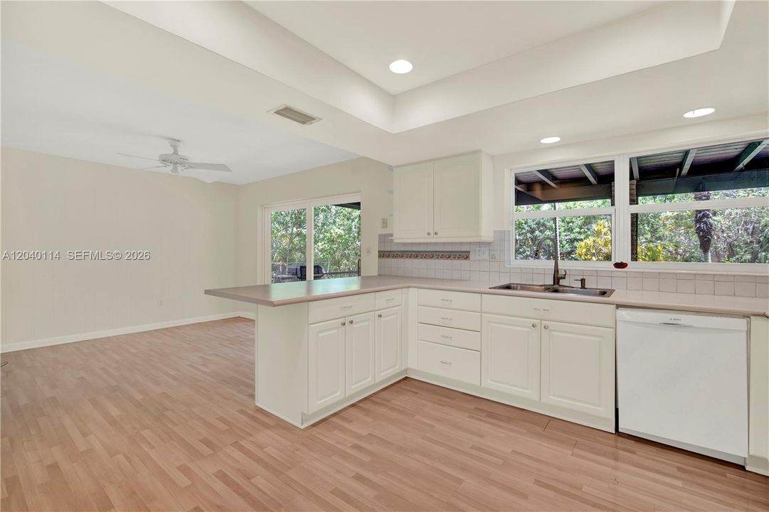 Kitchen opens to the family room with patio and backyard access