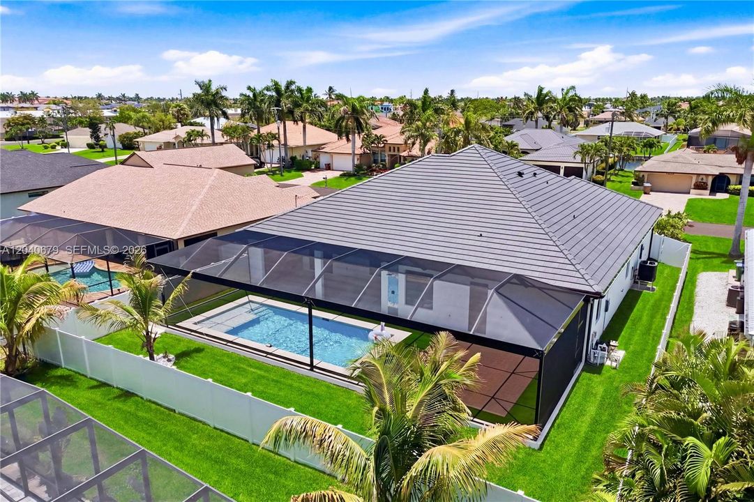 Expansive screened lanai creates the perfect outdoor retreat, offering seamless indoor-outdoor living with a private pool and ample space for relaxing or entertaining year-round