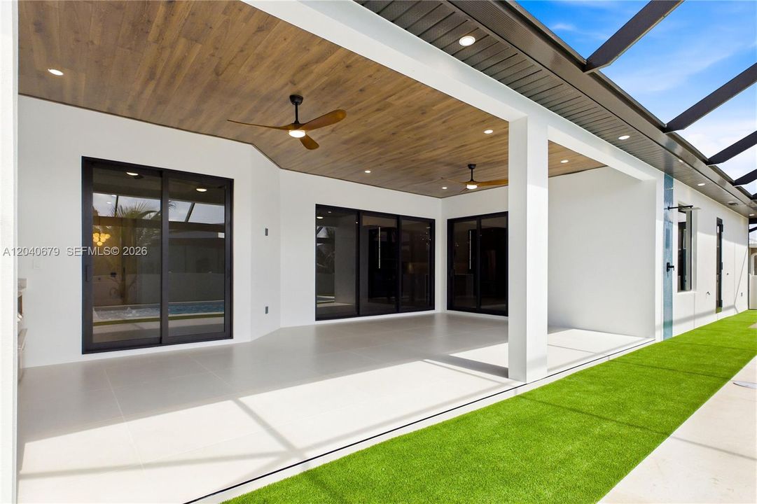 Expansive covered lanai w/ flat wood ceiling offers abundant space for dining, lounging & hosting unforgettable gatherings!