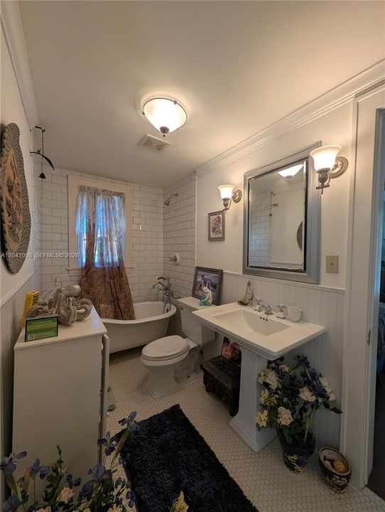 The upstairs bathroom has the hexagonal small tile on the floor and the pedestal "OLD" Tub!!