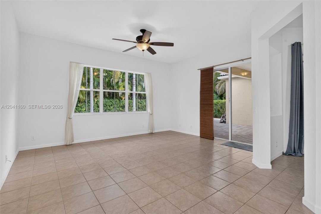 Primary bedroom with sliding glass doors leading to patio and pool.