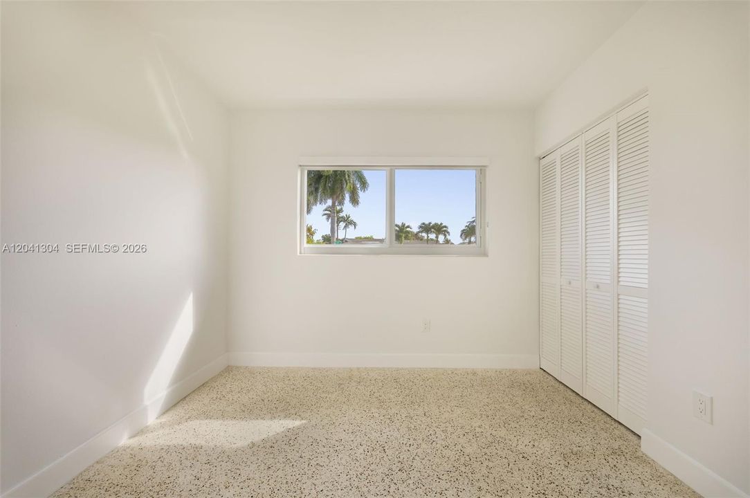 Bedroom – Light-filled bedroom featuring a large window and built-in closet storage. A comfortable and versatile space suitable for a variety of needs.
