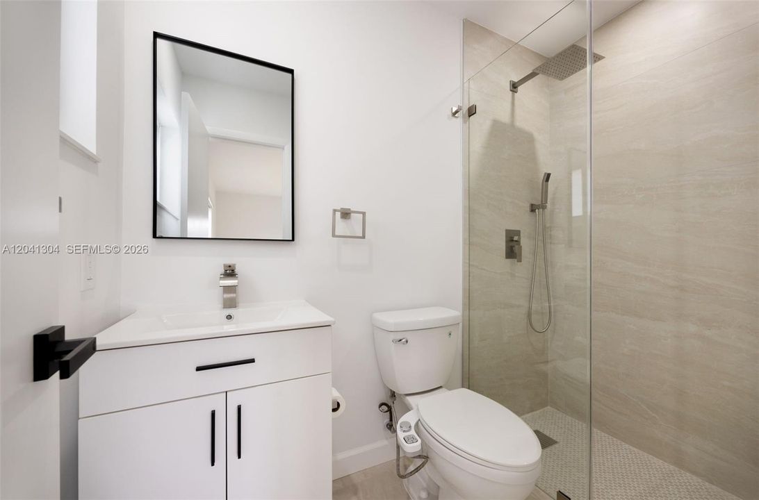 Bathroom – Modern full bathroom with stylish vanity, upgraded fixtures, and a spacious glass-enclosed shower. Thoughtfully finished for both comfort and functionality.