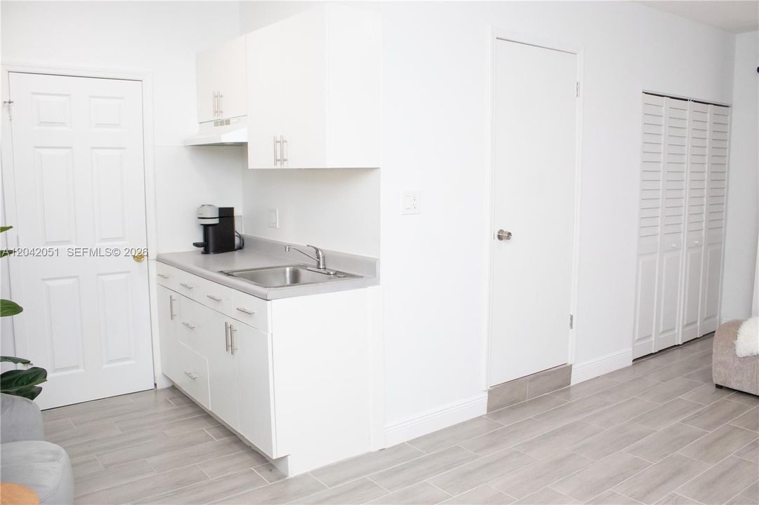 The 2-Car Garage was converted into a Studio/Home Office with a door that leads to the Laundry Area of the home, and a second door that leads to the an exterior entrance. There is a closet as well as a full bath and a wet bar. It is currently used as a Photography Studio.