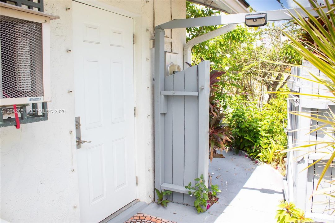 There is a sidewalk and a gated entrance that leads to the exterior independent door of the Studio/Home Office. Which is the white door you see on the left in the photo.