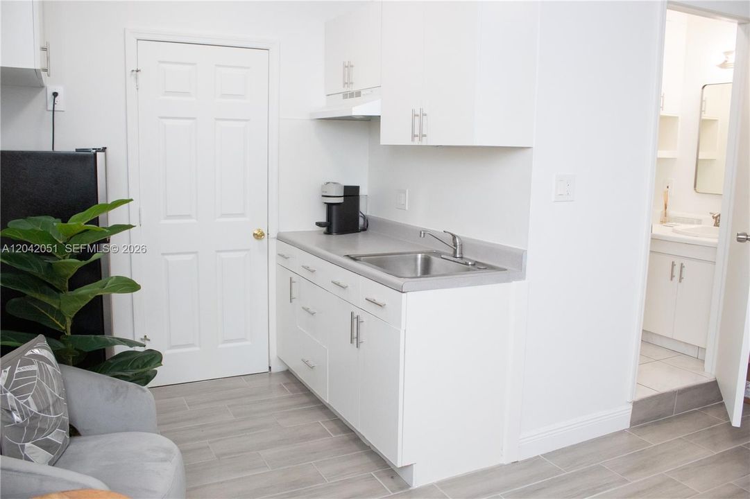 The 2-Car Garage was converted into a Studio/Home Office with a door that leads to the Laundry Area of the home, and a second door that leads to the an exterior entrance. There is a closet as well as a full bath and a wet bar. It is currently used as a Photography Studio.