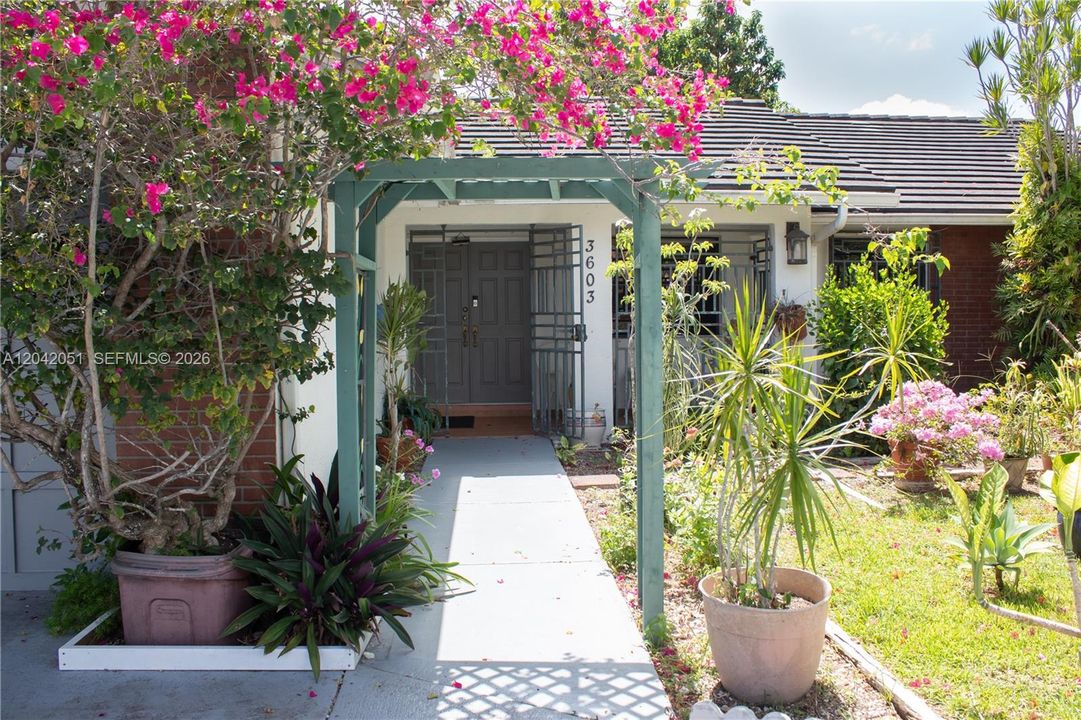 This is the main entrance of the home. On the front yard, there are beautiful flowers as well as a small pond with Koi Fish, and it has a small motor.