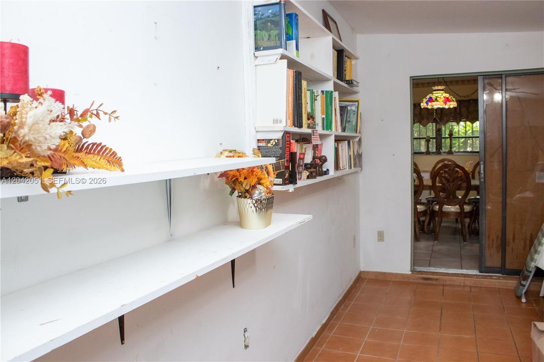 The Florida Room is currently used as storage but it is very spacious and has a closet, window, door to backyard and door to the hallway bathroom.