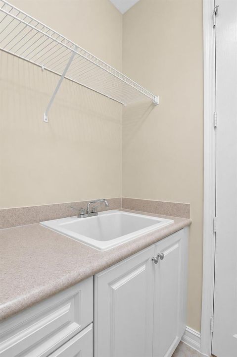 Laundry Room W/ Storage and Utility Sink