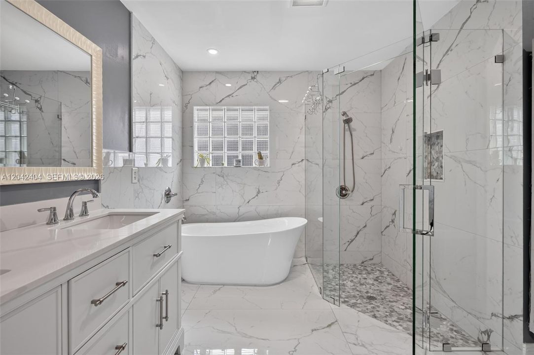 Beautifully updated primary bath with modern free form tub.