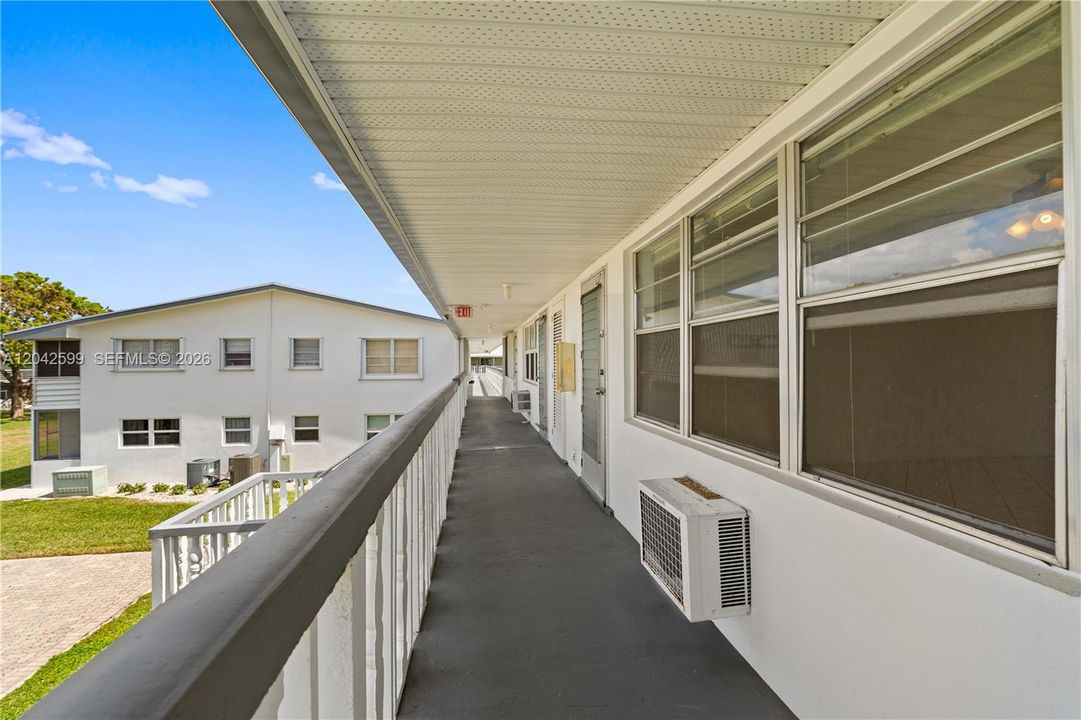 Bright, well-kept exterior hallway leading to your home