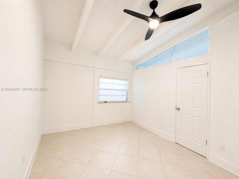Versatile bonus room with vaulted ceilings, offering endless possibilities for a home office, fitness room, playroom, or additional living space.