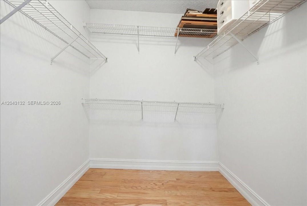 Main bedroom walk in closet. Virtually staged