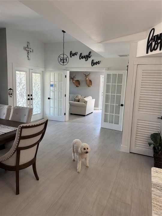 View of the entrance, recreational room, and dining from the kitchen.
