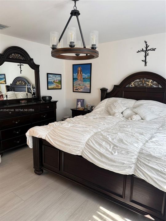 The Master bedroom is large enough to have two large dressers and two large nightstands with a king size bed.